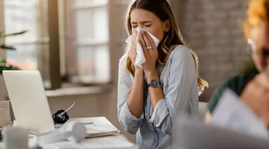 A women is sneezing due to allergy fusebay